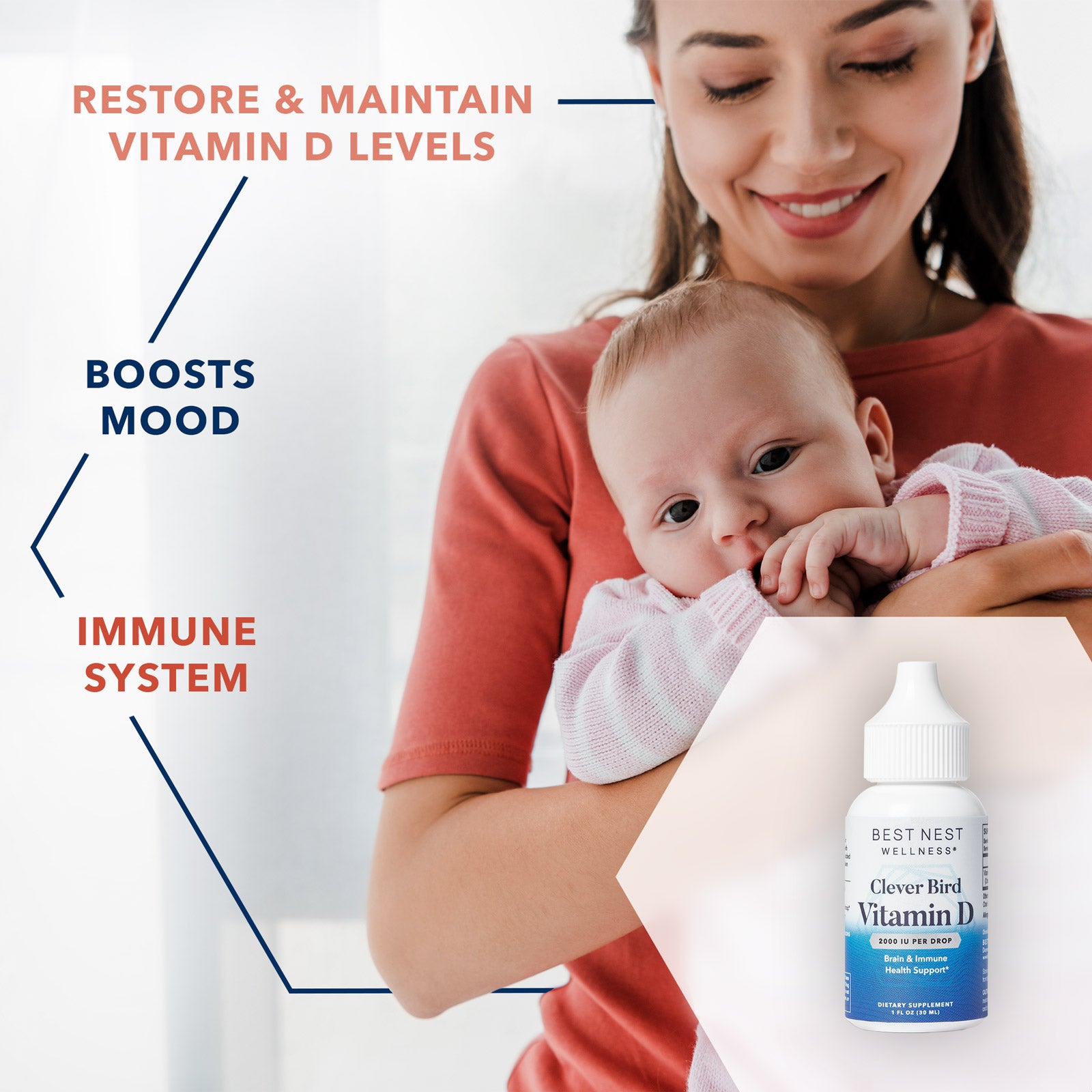 A woman holding a baby next to a bottle of Vitamin D Drops.