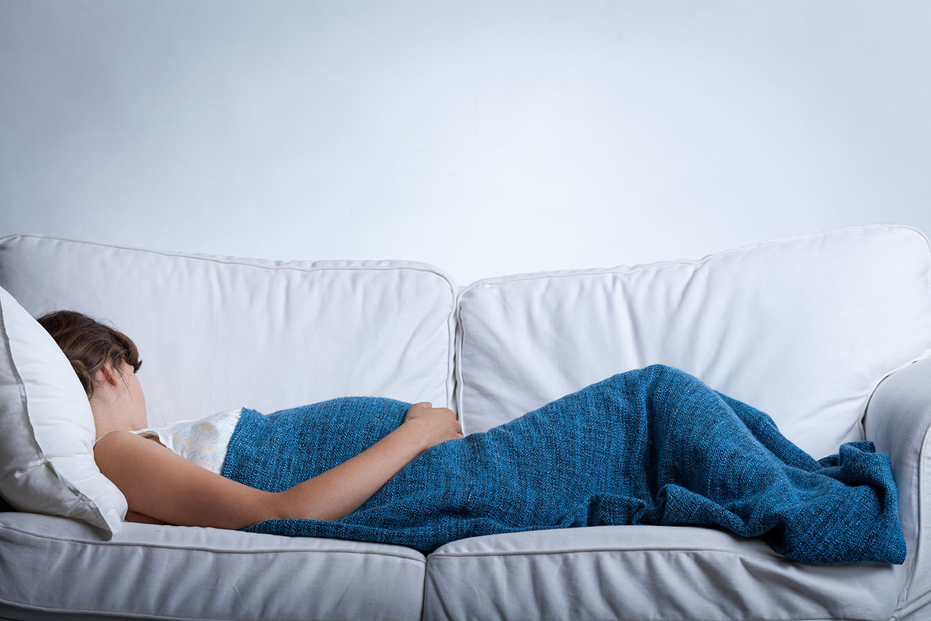 Pregnancy and Sleep. Pregnant woman asleep on sofa. Tips for a good night’s sleep. Sleep & nutrition